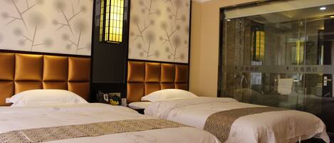 A hotel room with two beds, a large window, and a decorative wall panel.