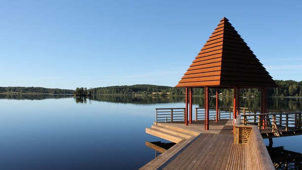 A wooden pier extending into calm water, with a triangular gazebo at the end. - Lindesbergs Stadshotell (Lindesberg)