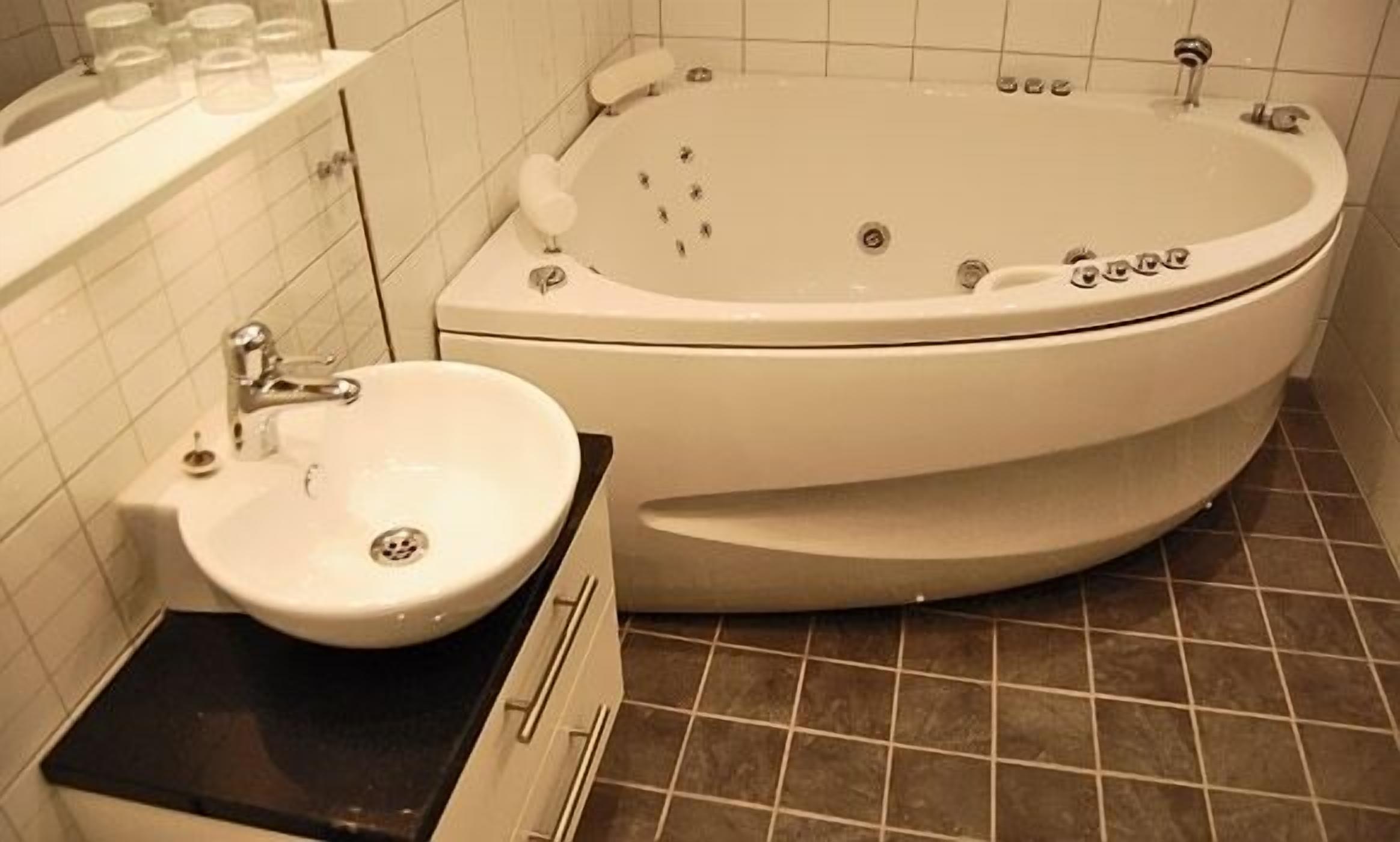 A bathroom with a bathtub, a sink, and a toilet.