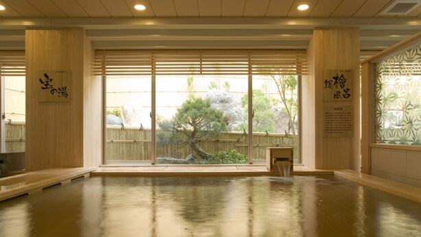 A spacious room with a polished wooden floor, large sliding doors with a view of a garden, and traditional Japanese decor. - -SPA RESORT- Nagoya Kasadera Hotel (Nagoya)