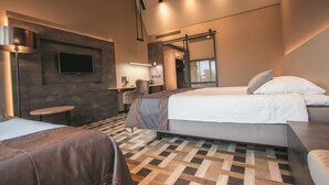 A modern hotel room with a large bed, a smaller bed, a desk, and a TV mounted on the wall. - Best Western Hotel Nobis Asten (Asten)