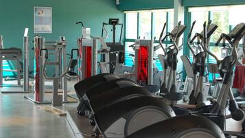 A gym with various exercise equipment including treadmills and weight machines.