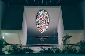 A modern building with a large, colorful stained glass window. - Grand Muthu Forte do Vale (Albufeira)