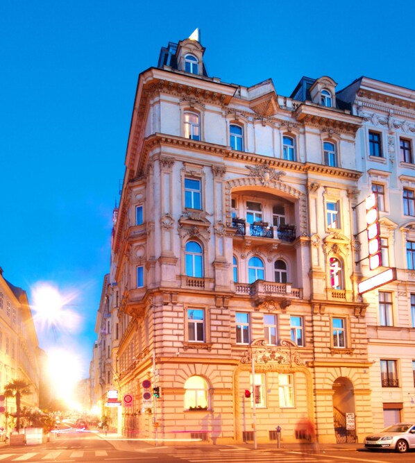 A historic building with ornate architecture, multiple balconies, and a prominent entrance.