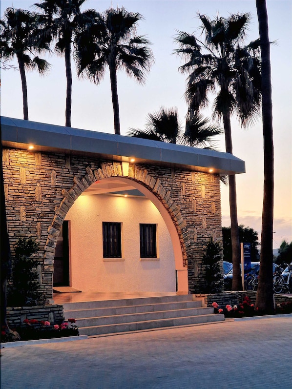 A building with a stone facade, two windows, and a set of steps leading to the entrance. - Sveltos Hotel (Oroklini)