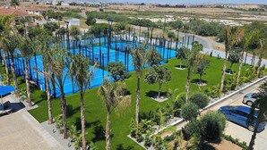 A swimming pool surrounded by palm trees and sun loungers. - Sveltos Hotel (Oroklini)