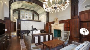 A grand room with a large wooden desk, a comfortable sofa, and a chandelier. - DoubleTree By Hilton Hotel & Spa Liverpool (Liverpool)