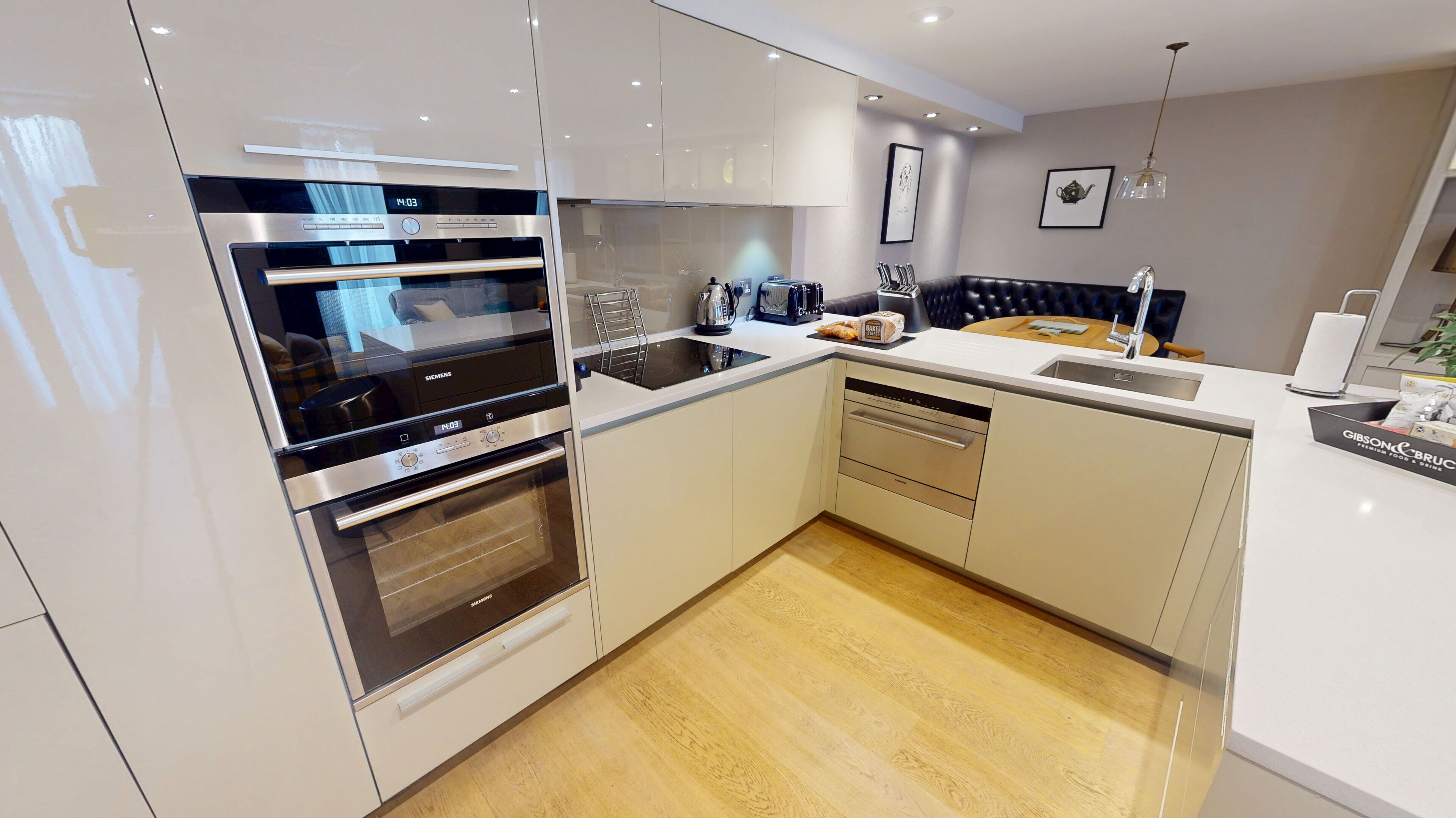 A modern kitchen with stainless steel appliances, a built-in oven, and a dishwasher.