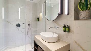 Deluxe Two Bedroom Apartment | Bathroom | Shower, rainfall showerhead, designer toiletries, hair dryer