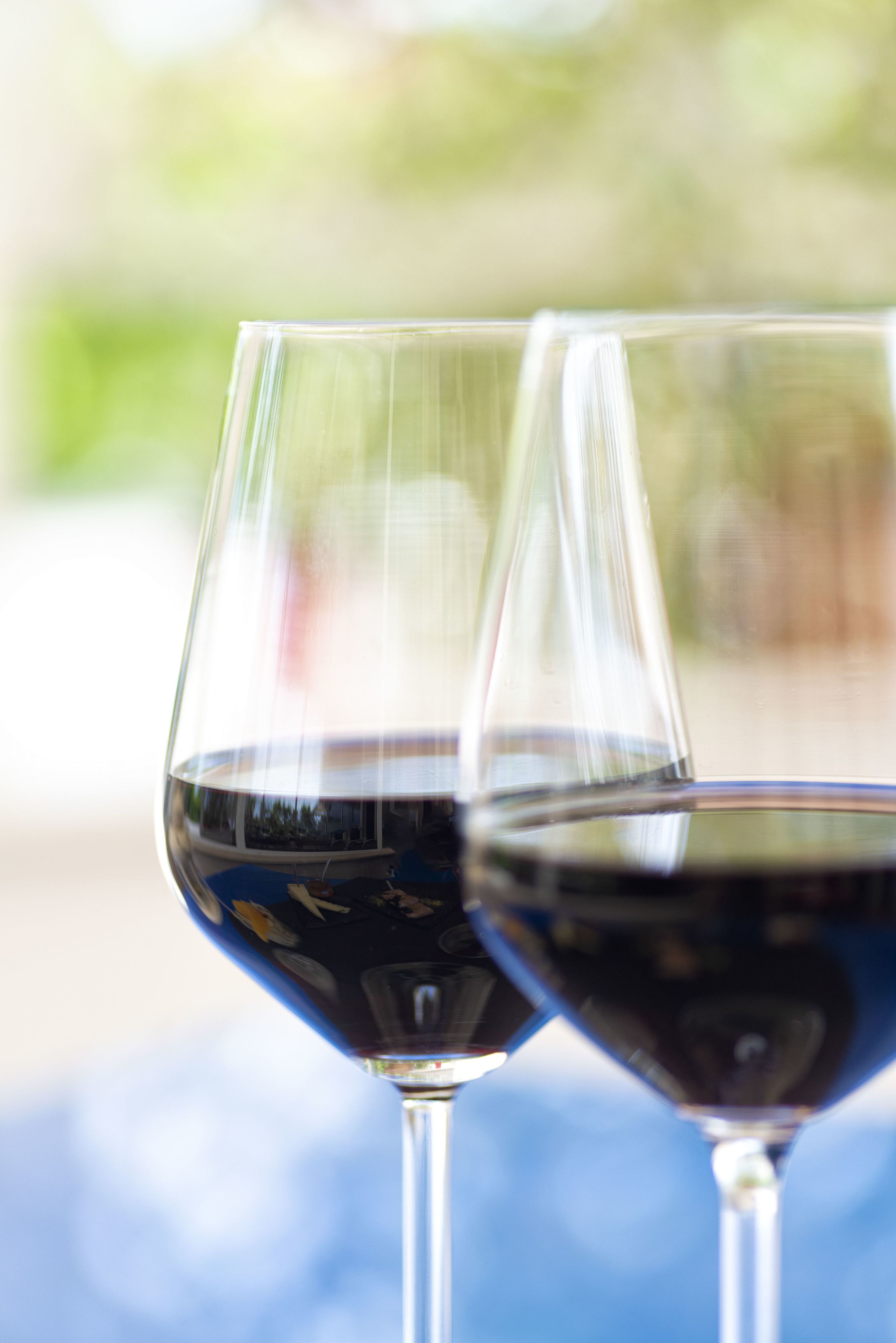 Two wine glasses filled with red wine.