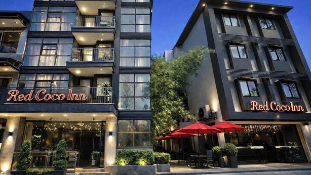 A modern hotel with multiple floors, balconies, and outdoor seating areas. - Red Coco Inn de Boracay (Boracay Island)