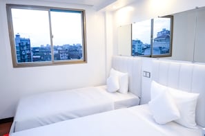 A hotel room with a large window, a bed with white bedding, and a mirror on the wall. - Clover Hotel City Center (Yangon)