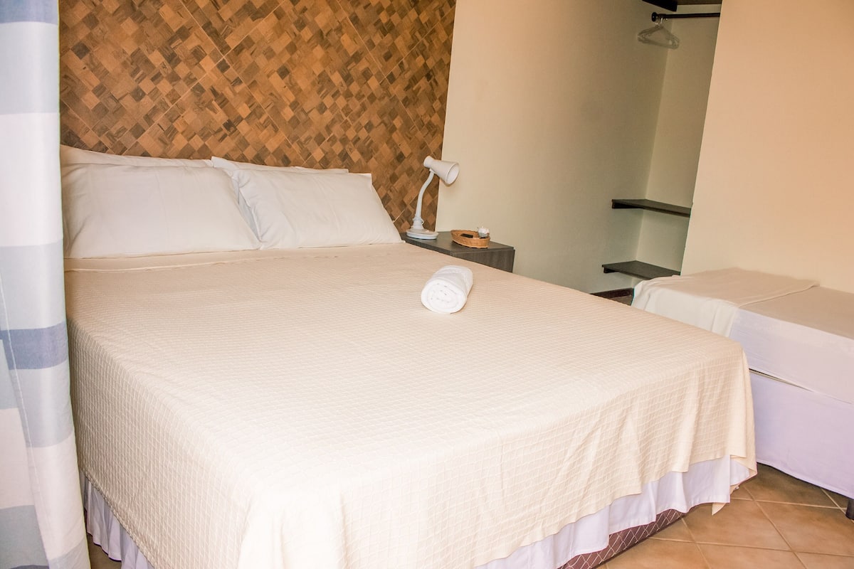Economy Triple Room | Bar mini, peti besi dalam bilik, meja, langsir/tirai gelap terus