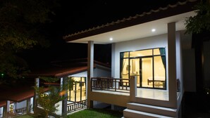 A modern house with a covered porch, a staircase leading to the entrance, and a well-maintained lawn. - Sun Moon Star Resort Koh Phangan (Ko Pha-ngan)