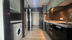 A modern kitchen with a built-in washing machine, a sink, and a countertop.
