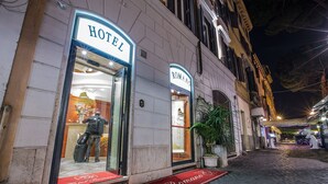 A hotel entrance with a red carpet and a sign reading "Hotel Romano". - Hotel Romano (Rome)