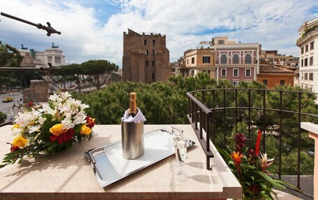 A balcony with a metal tray, a bottle of champagne, and a glass.