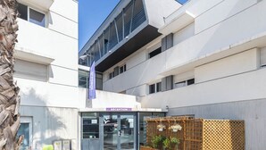 A modern building with a reception area, multiple floors, and a balcony.