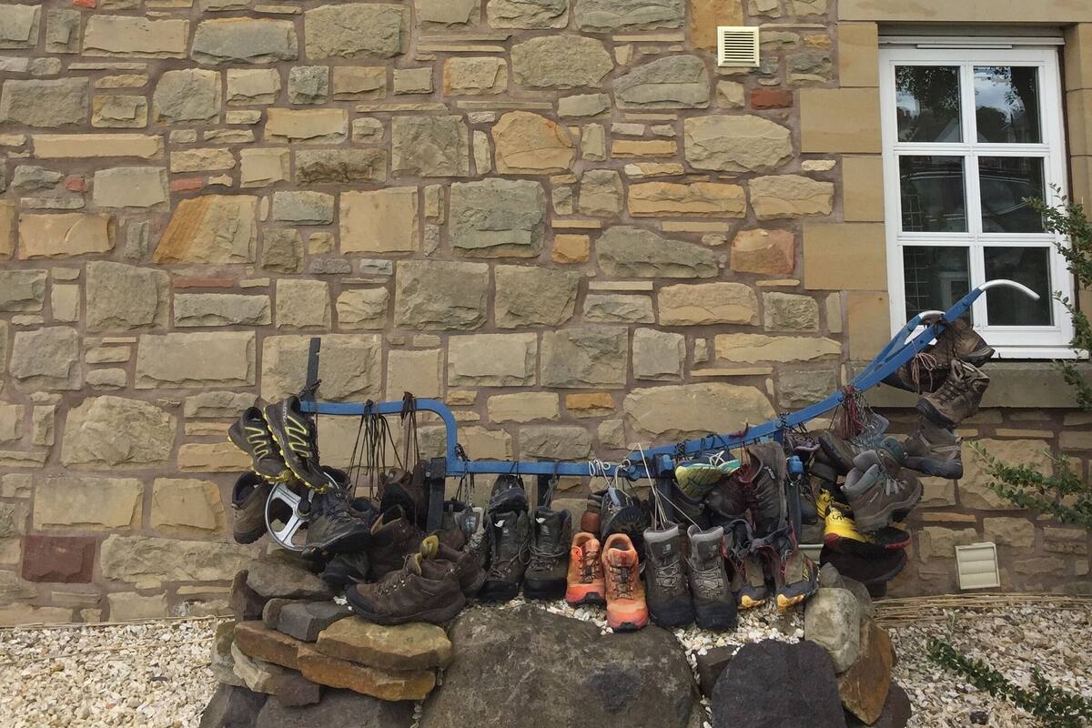 A stone building with a sign reading "The Border hotel end of the Pennine Way".