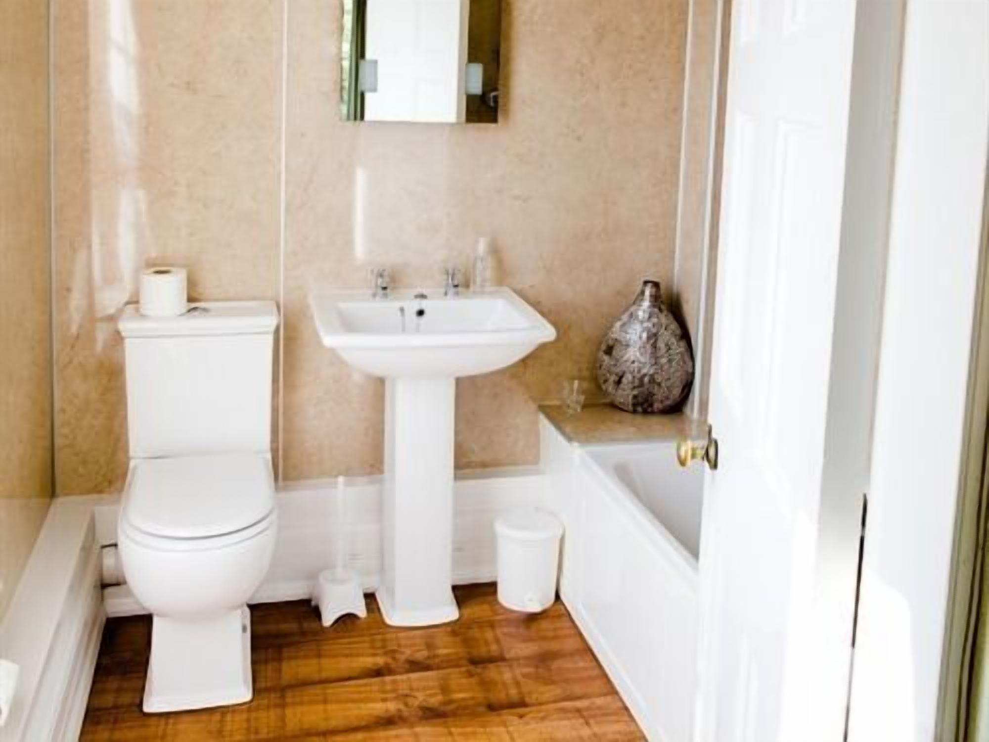 A small bathroom with a toilet, sink, and bathtub.