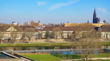 A riverside view with a bridge, buildings, and a prominent tower.