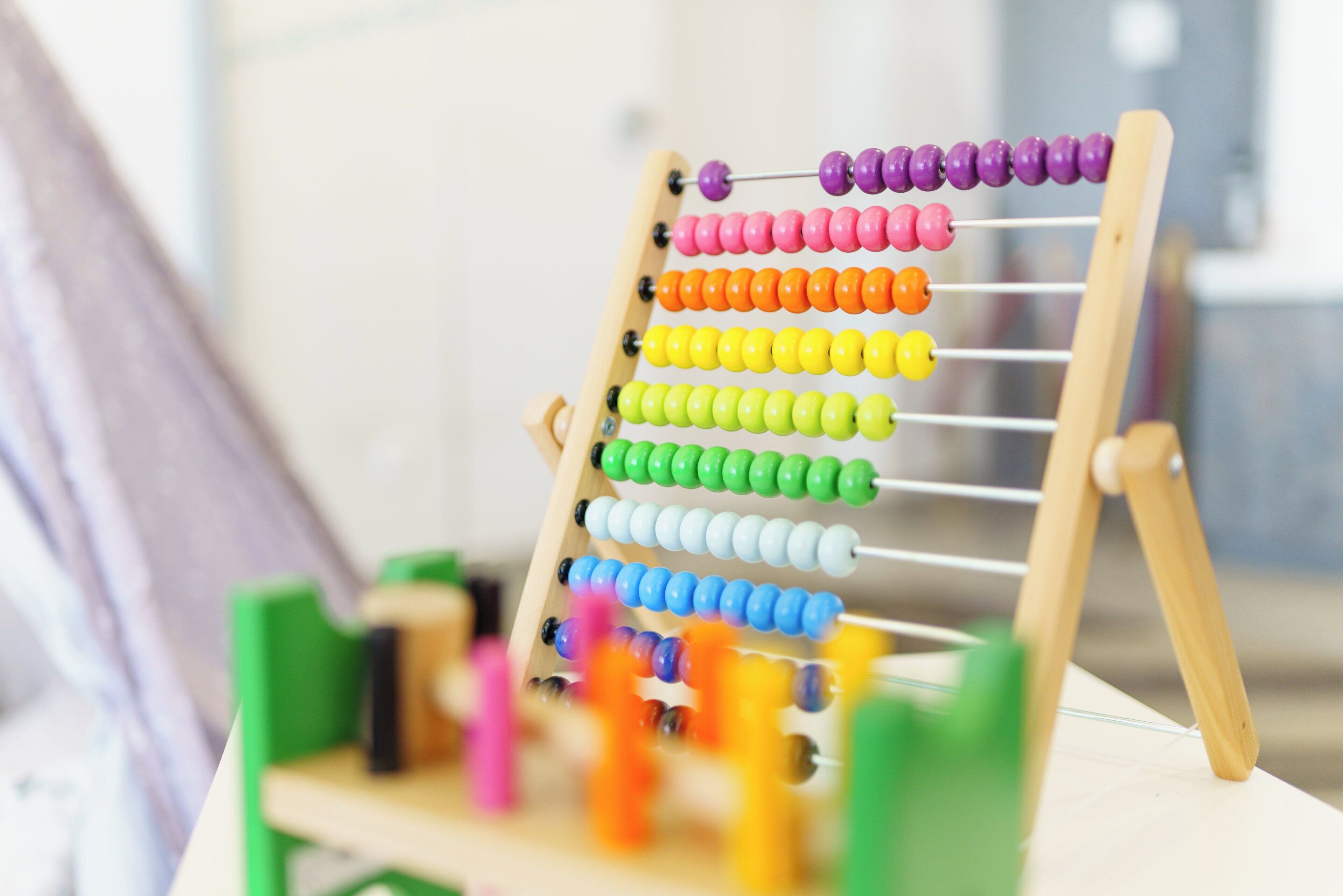 A wooden abacus with colorful beads.