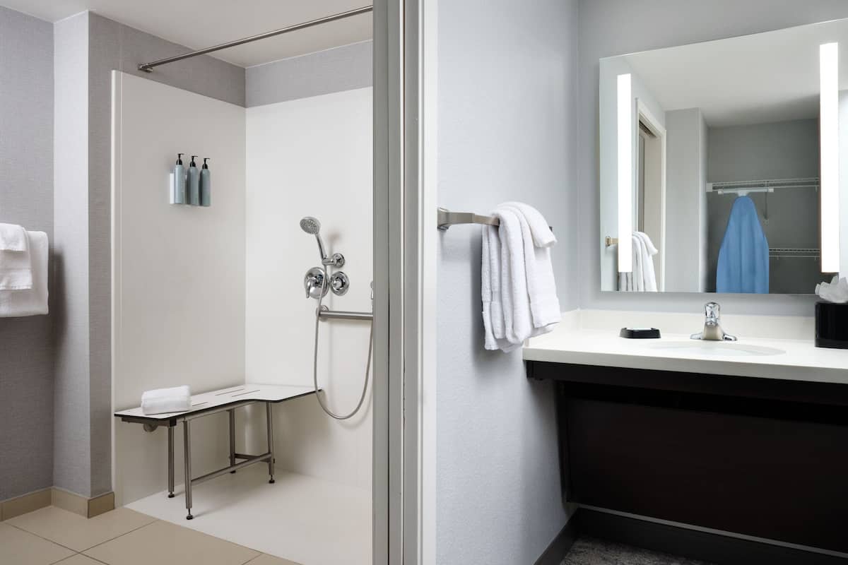 Studio Suite, 1 King Bed with Sofa bed (Mobility Accessible, Roll-In Shower) | Bathroom | Combined shower/bathtub, hydromassage showerhead, free toiletries