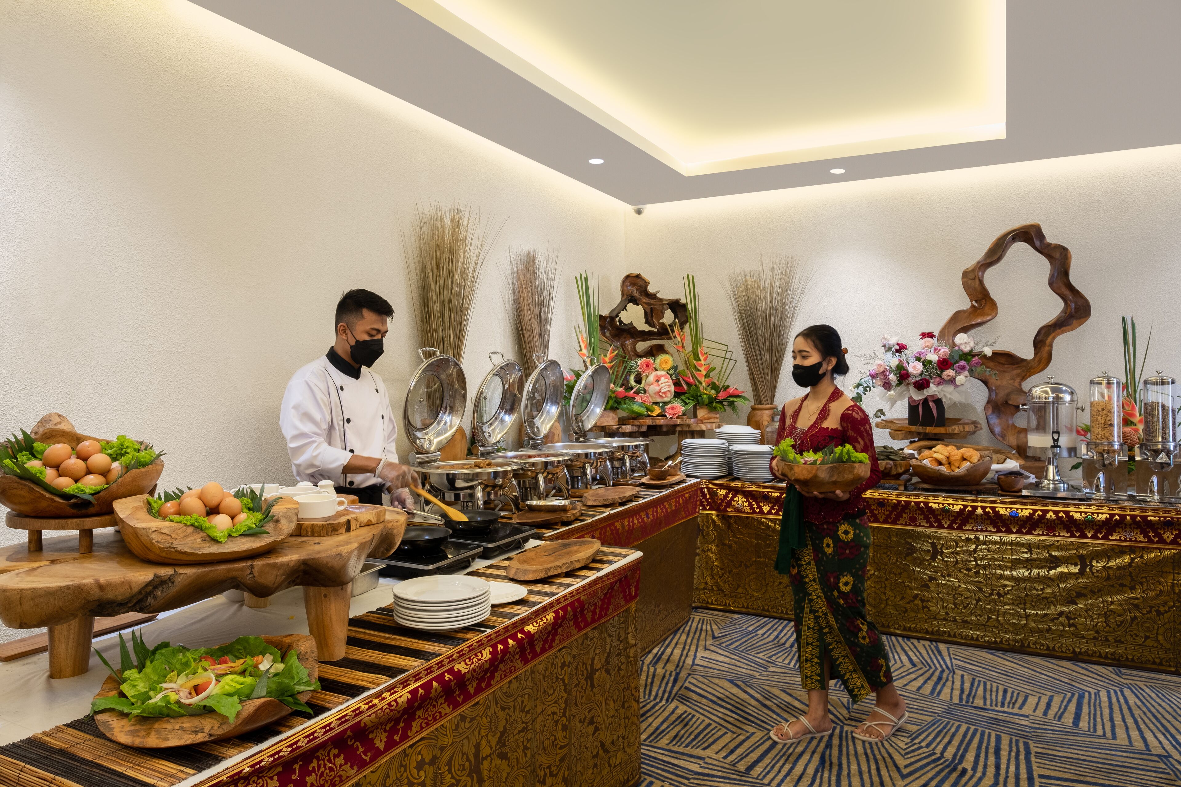 A buffet setup with various food items and a decorative centerpiece.