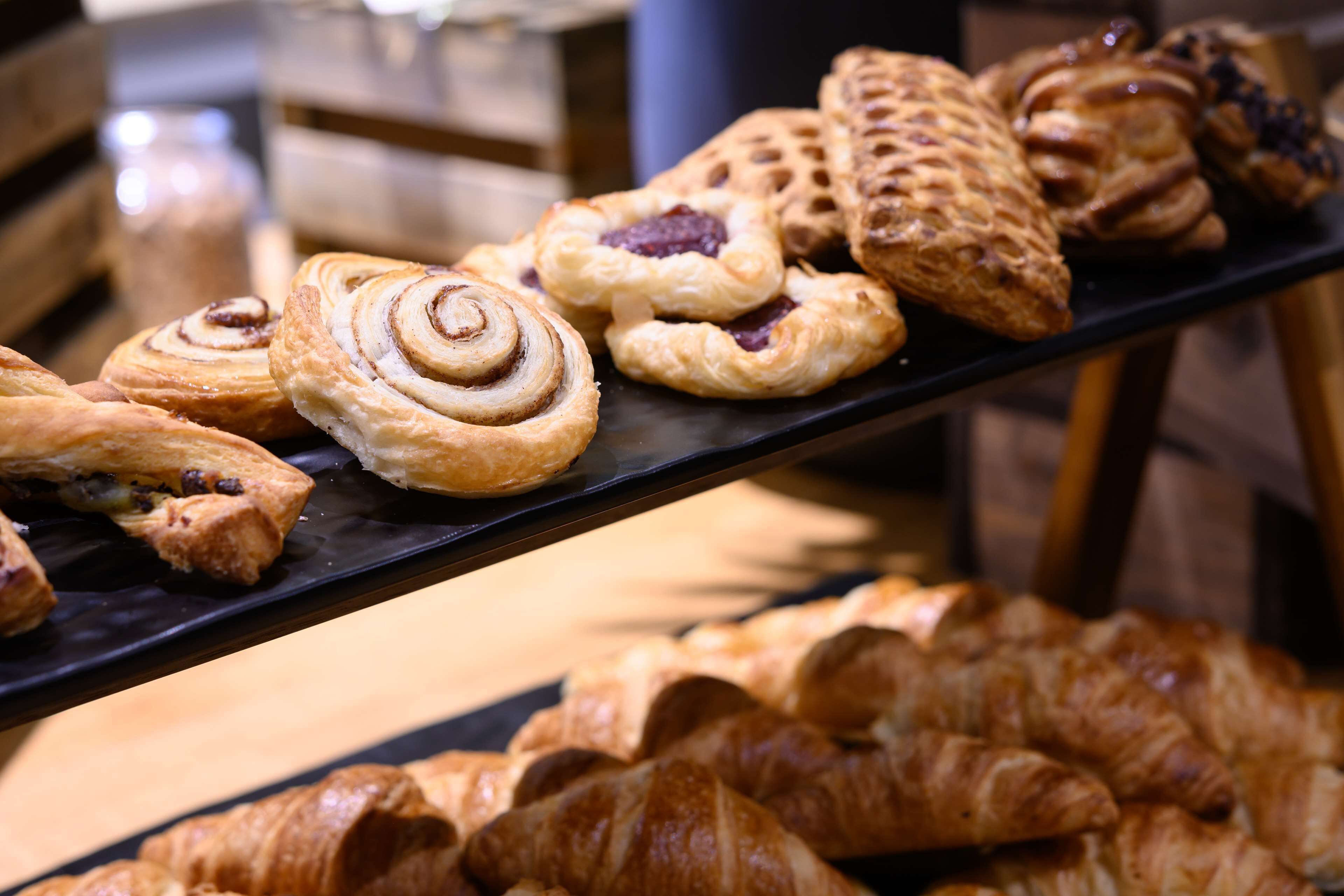 A variety of pastries displayed on a black tray.