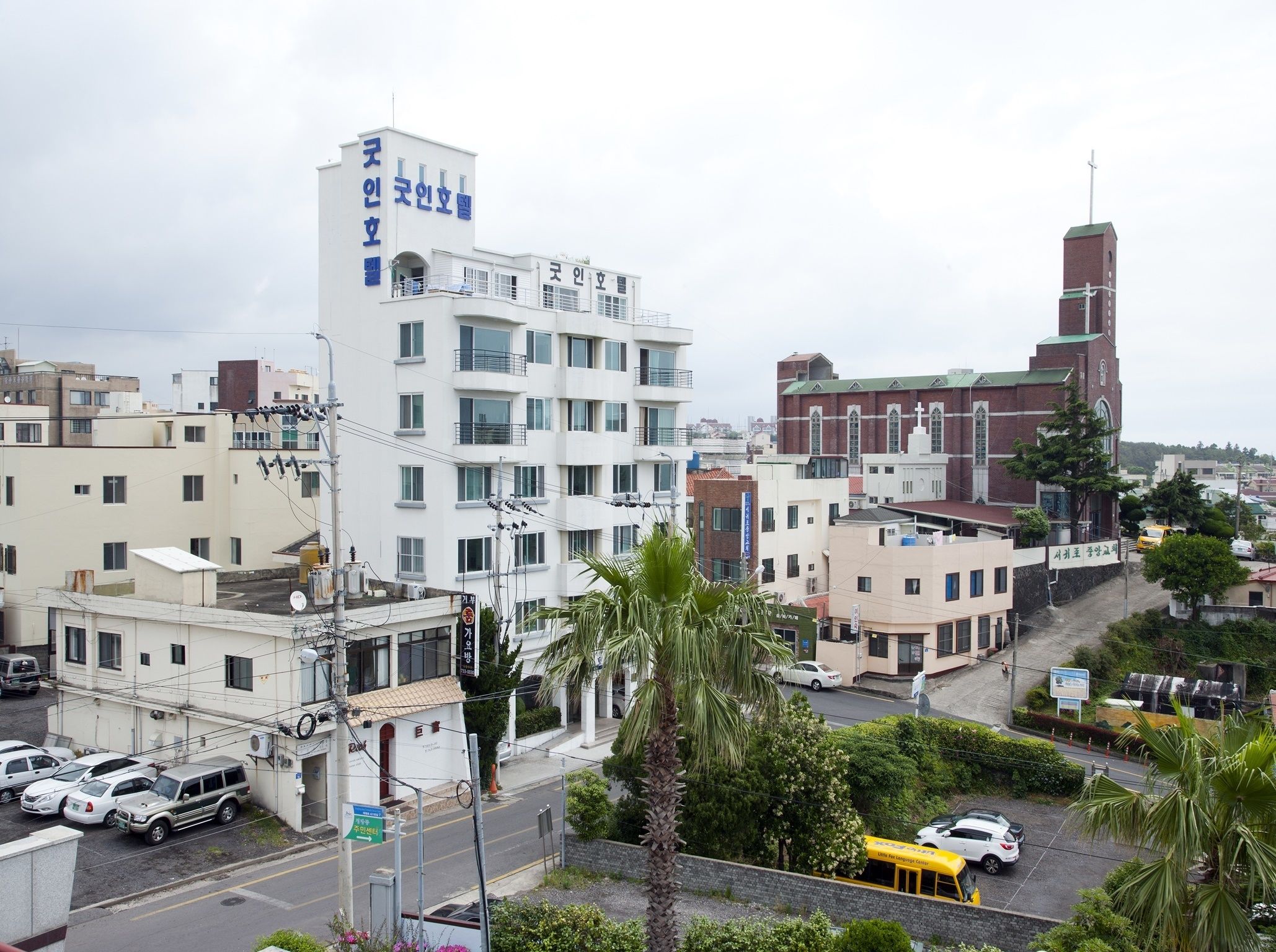 A multi-story building with a sign indicating it is a hotel.