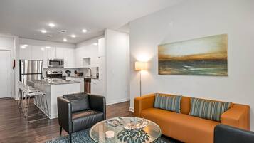 A modern apartment with a kitchen, dining area, and living room.