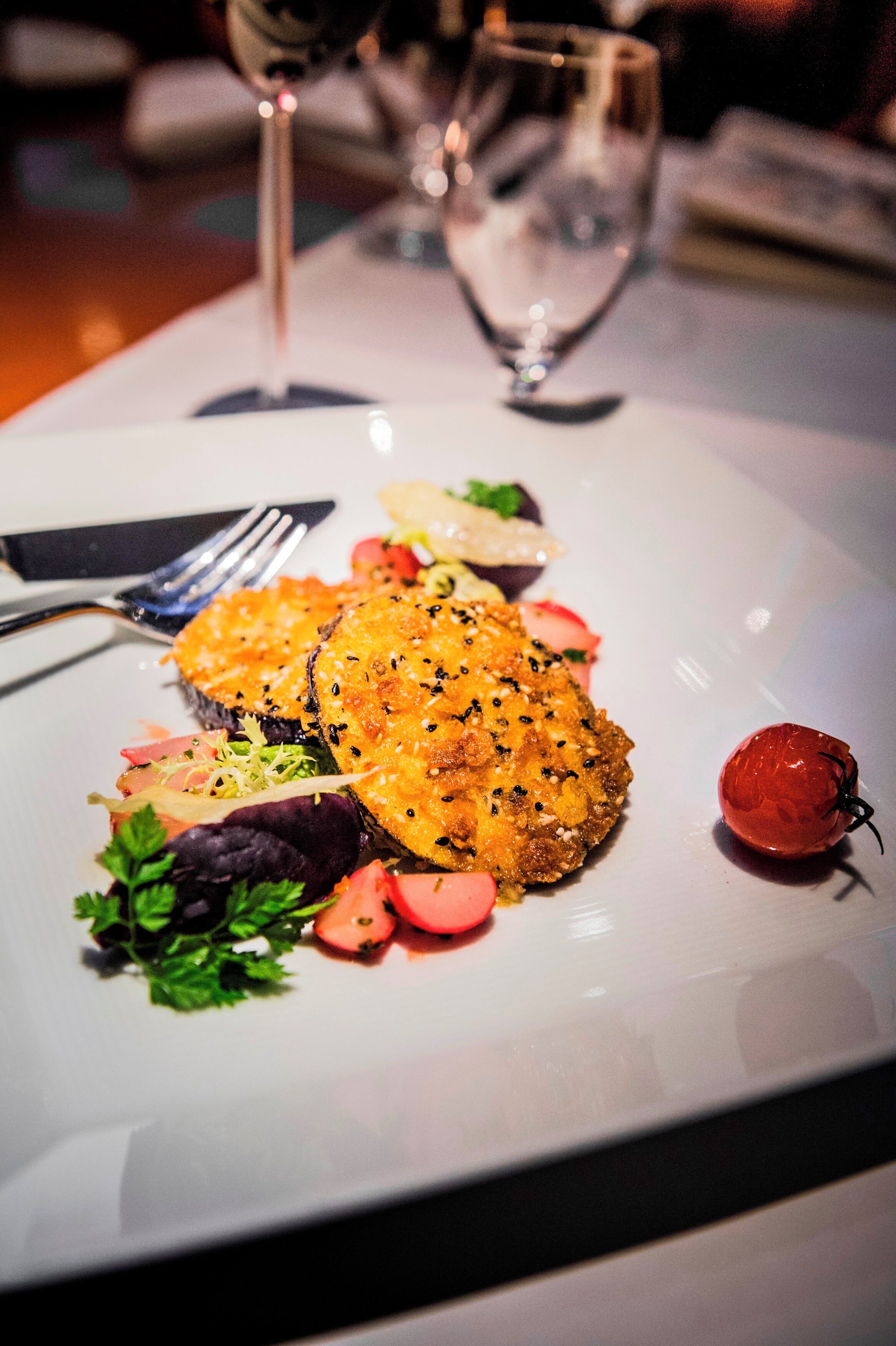 A plated dish with various garnishes and a fork.