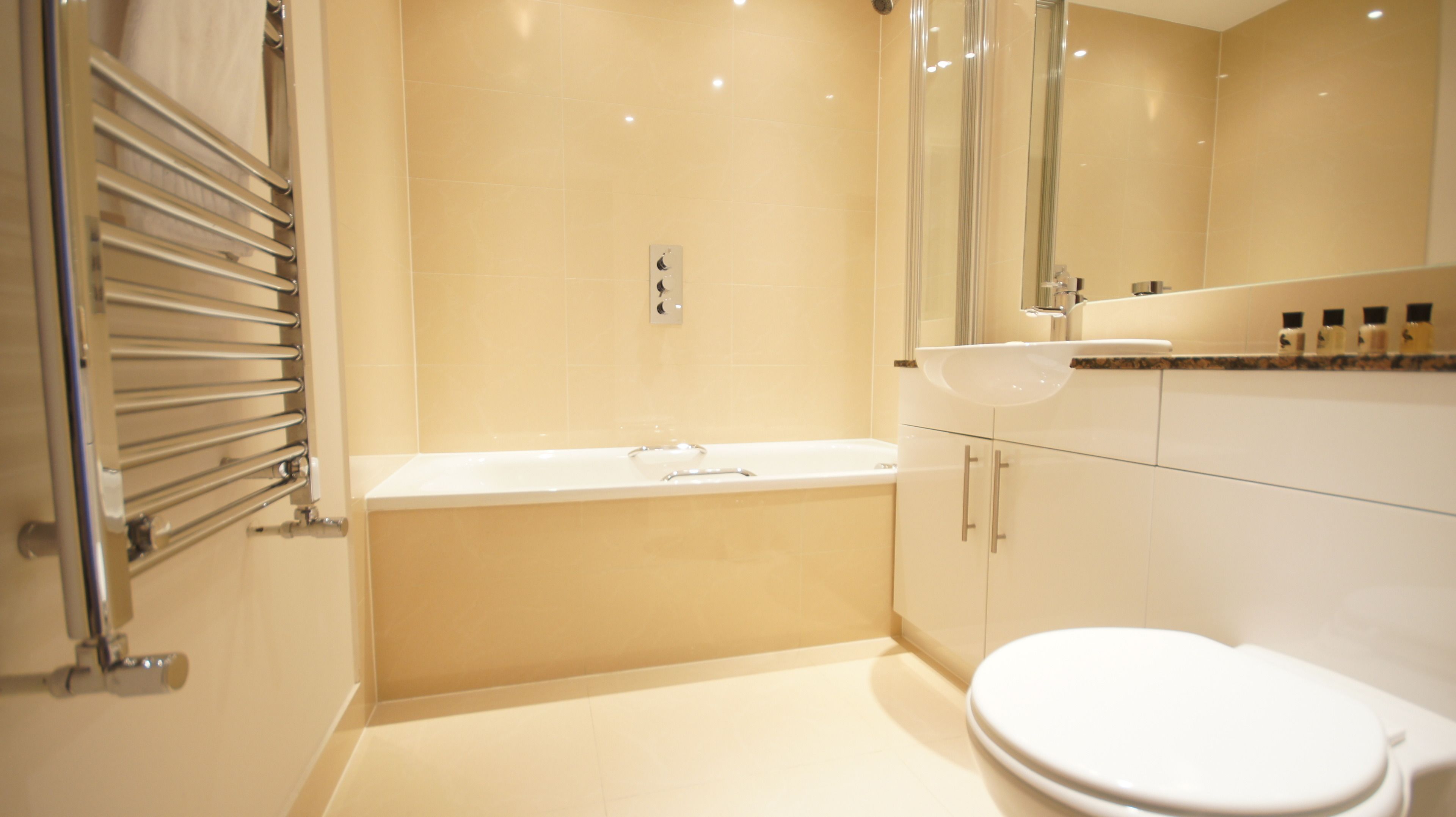 A modern bathroom with a bathtub, a sink, and a toilet.