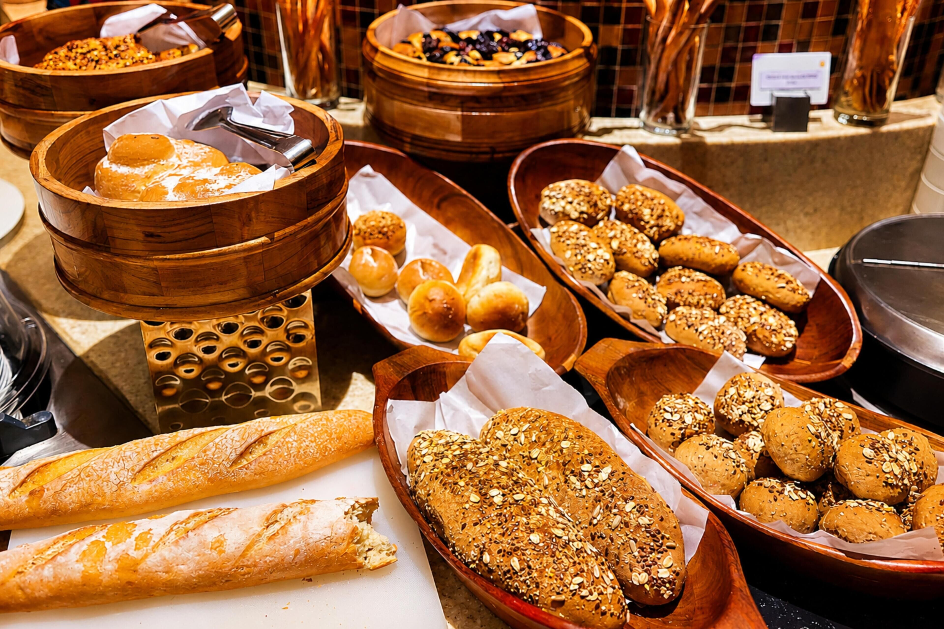 A variety of baked goods displayed in wooden bowls and baskets.