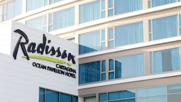 A hotel sign with the name "Radisson" and "Cartagena Ocean Pavilion Hotel" visible.