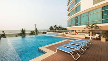 Outdoor pool, open 7:30 AM to 8:00 PM, pool loungers, lifeguards on site