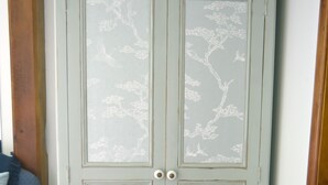 A light green wardrobe with floral patterns and two doors. - Hazel Barn B&B (Diss)