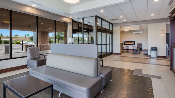 A modern lobby with a seating area, large windows, and a television. - Best Western Northwest Indiana Inn (Hammond)