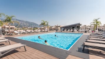 Seasonal outdoor pool, pool loungers