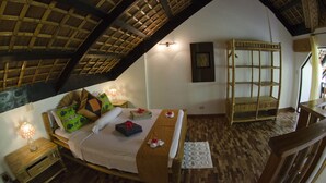 A room with a bed, a nightstand, a wooden bench, and a shelf.