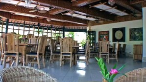A spacious indoor area with wooden furniture and a high ceiling.