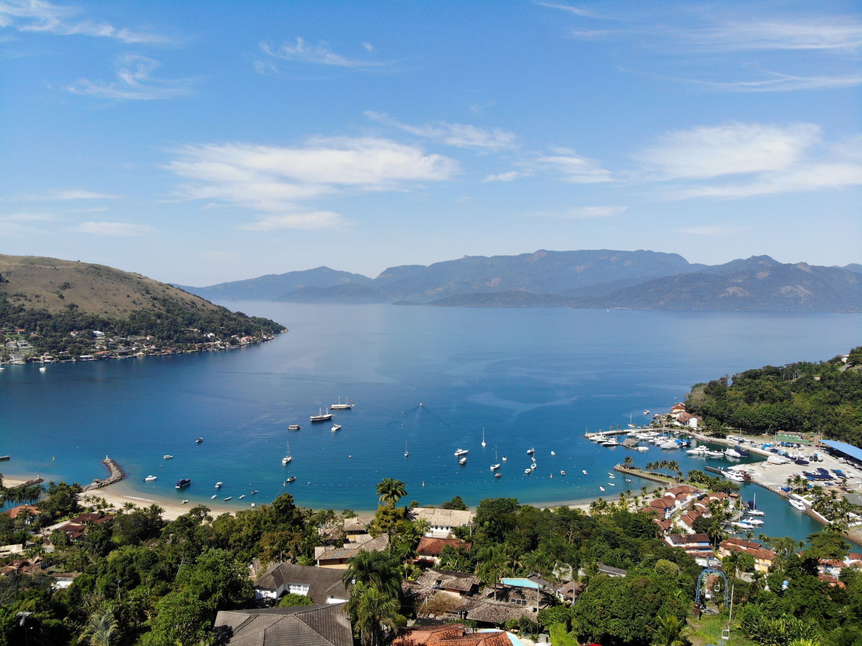 A coastal town with a marina, boats, and residential buildings.