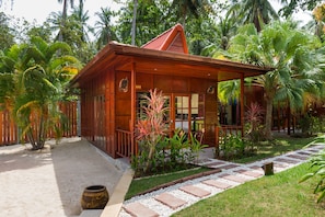 Deluxe Room, Beachfront | Minibar, in-room safe, desk, iron/ironing board