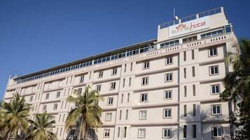A multi-story hotel with a flat facade, numerous windows, and a sign indicating it is a hotel.