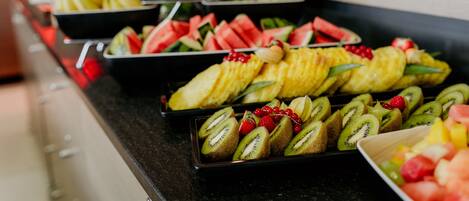 A buffet with various fruits and vegetables.