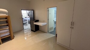 A bedroom with a bunk bed, a small desk, and a wardrobe. - Superpro Samui (Koh Samui)
