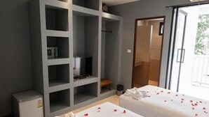 A hotel room with two beds, a minibar, a TV, and a sliding glass door to the outside. - Superpro Samui (Koh Samui)