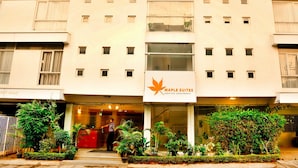 A building with multiple windows and a sign for Maple Suites. - Maple Suites Serviced Apartments (Bengaluru)