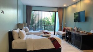 A hotel room with a large bed, a desk with a chair, a television, and a balcony with curtains. - Maikaew Damnoen Resort (Damnoen Saduak)