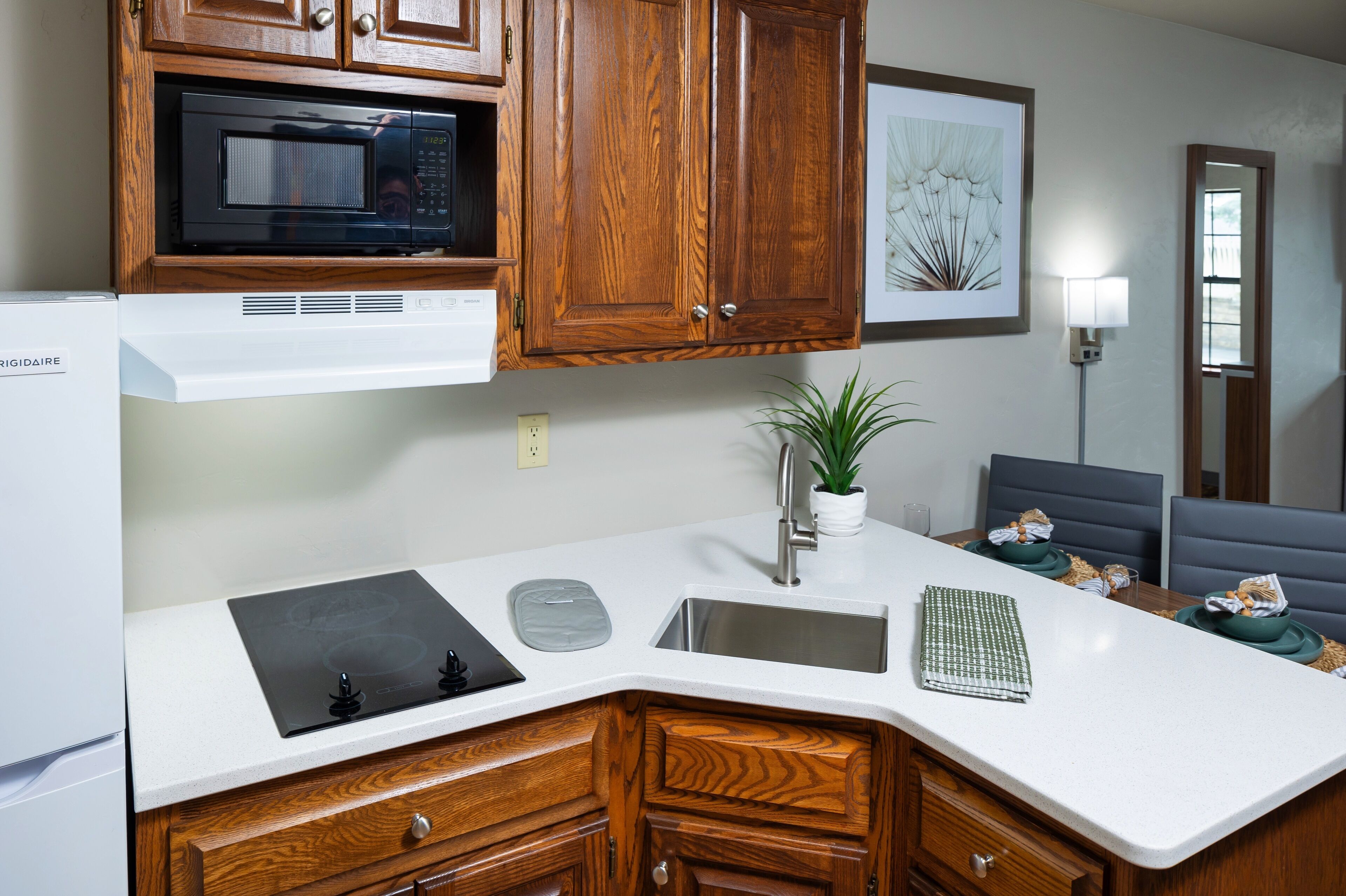 full-sized fridge, microwave, stovetop, coffee/tea maker